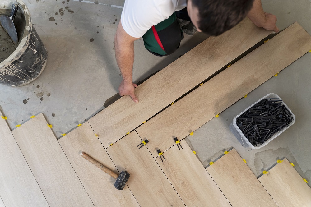 top-view-man-tiling-floor (2) Flooring Services in St. Louis